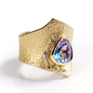 wide gold ring with mystic topaz and textured design