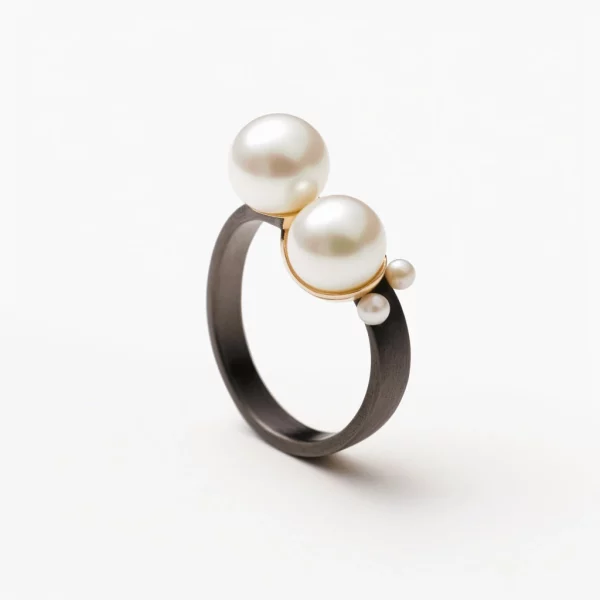 blackened silver ring with two pearls and gold accents