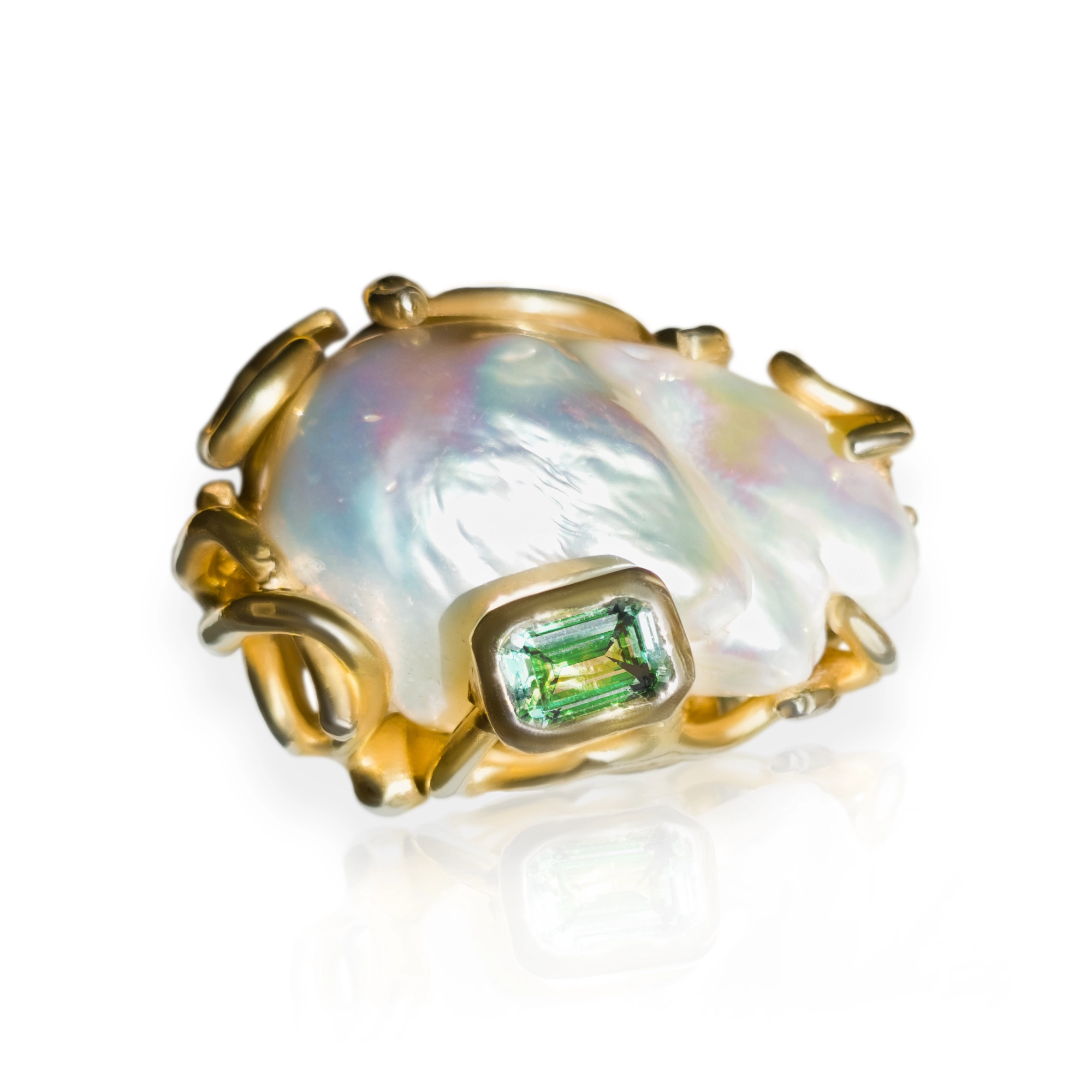 Sculptural ring set with a baroque pearl and a green gemstone by Magic Stones
