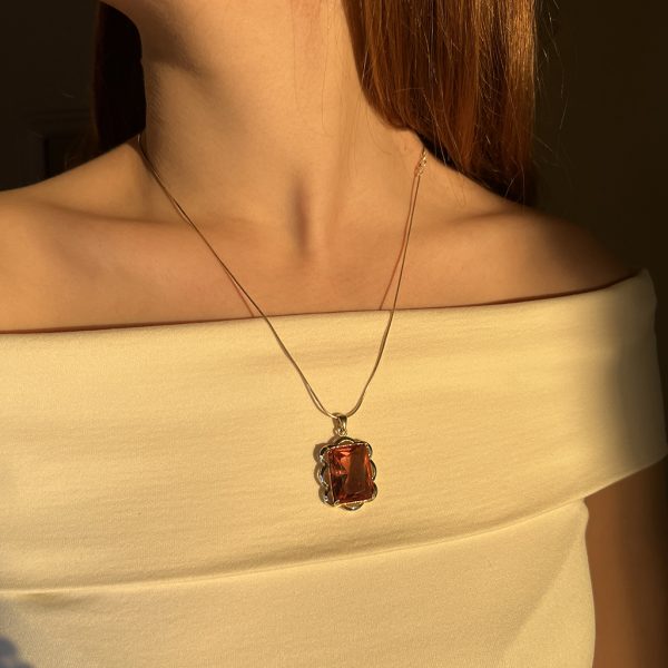 Zultanite Pendant in Sculpted Frame view 3, silver, gold plated, with zultanite, shown on person.