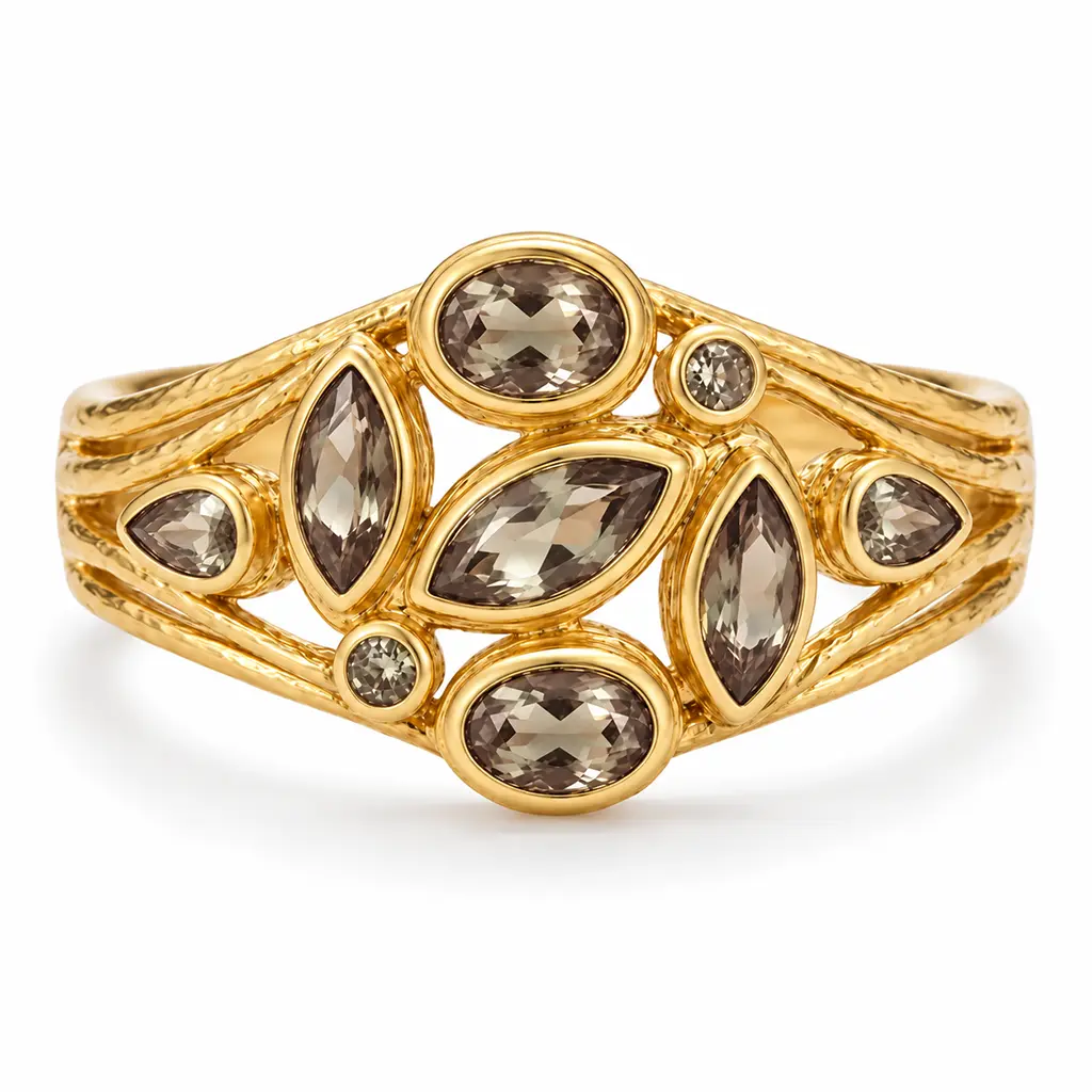 Front view of the 14K gold cuff bracelet, its lab-grown zultanite turned champagne under warm lamp light